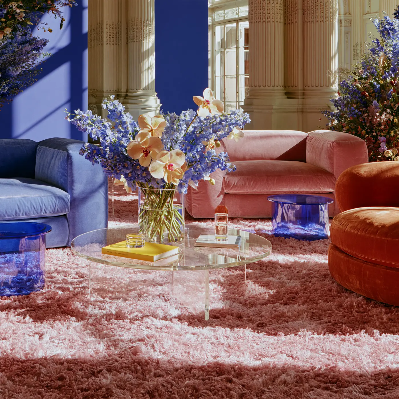 A brand space in deep blue and pink velvet with flowers and glass tables